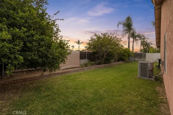 a backyard of a house with table and chairs plants and trees