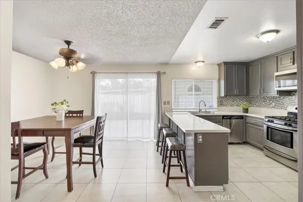 a kitchen with a table chairs stove and cabinets