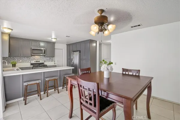 a view of a dining room with furniture and chandelier
