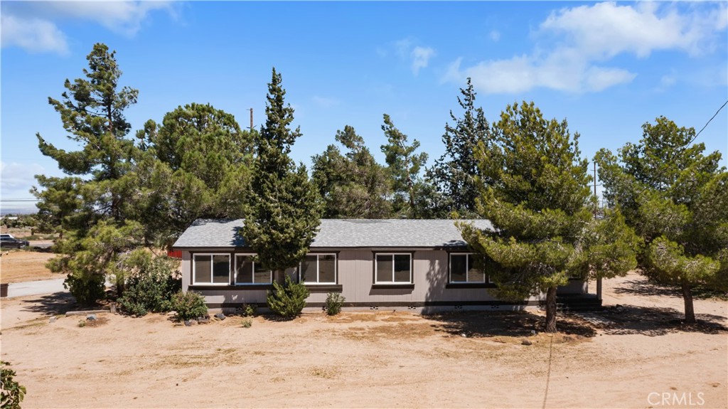 6374 Agoura Road Phelan, CA 92371 - Photo 1 of 1 a front view of a house with a yard