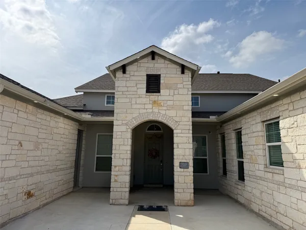 a front view of a house with a brick wall