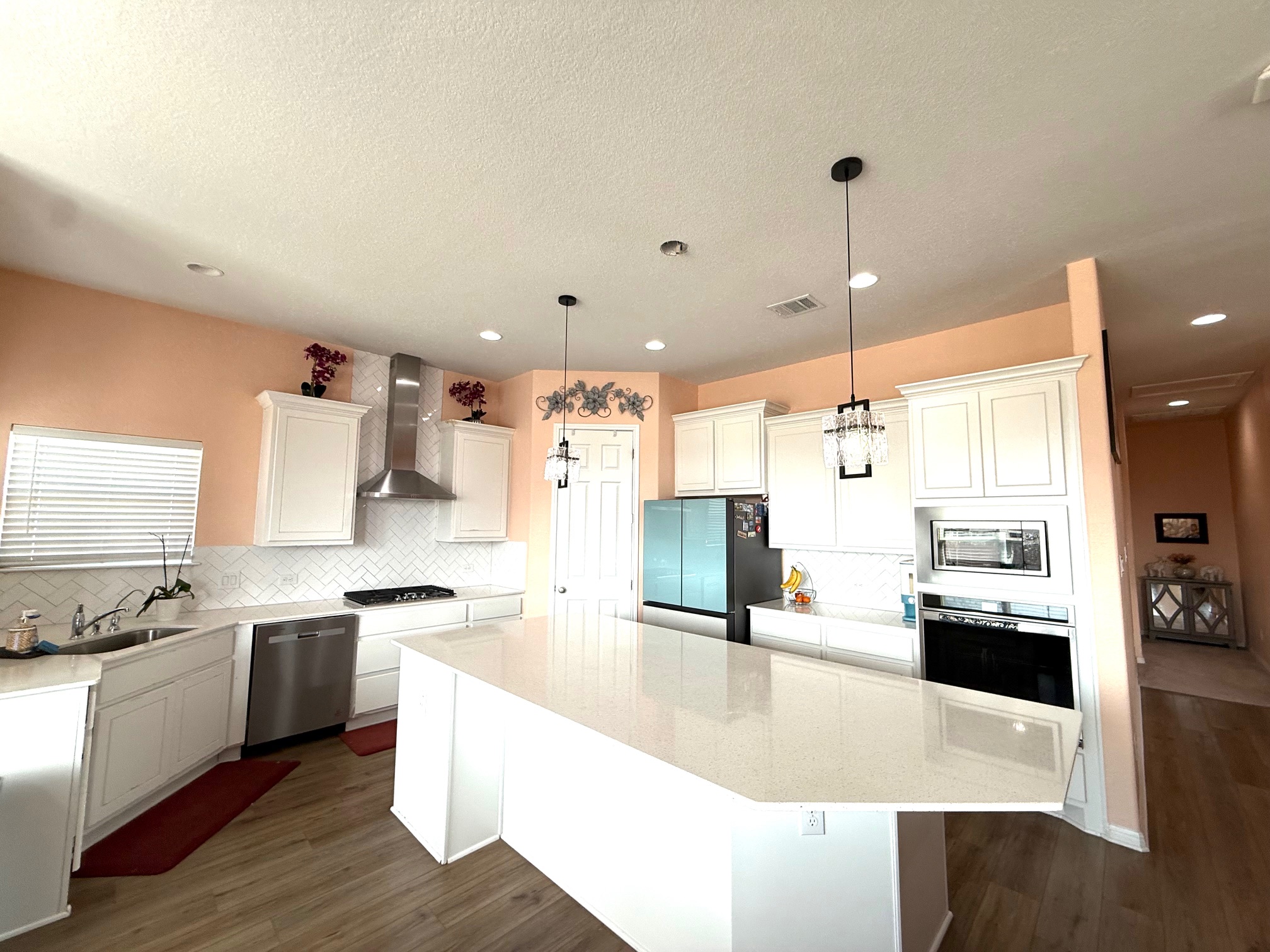 3625 Garrano Bend Leander, TX 78641 - Photo 11 of 31 a large kitchen with stainless steel appliances kitchen island granite countertop a sink and cabinets