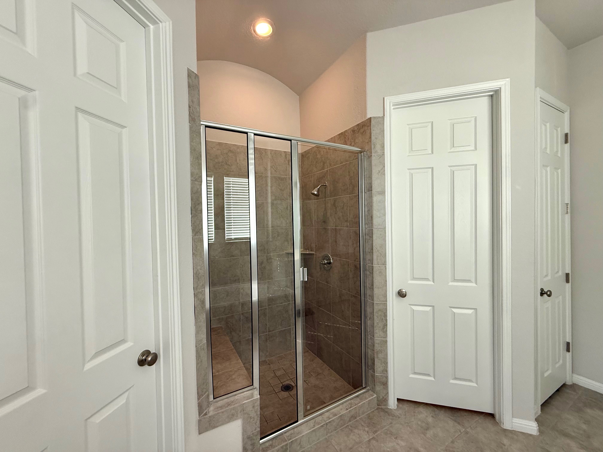 3625 Garrano Bend Leander, TX 78641 - Photo 16 of 31 a bathroom with a glass shower door