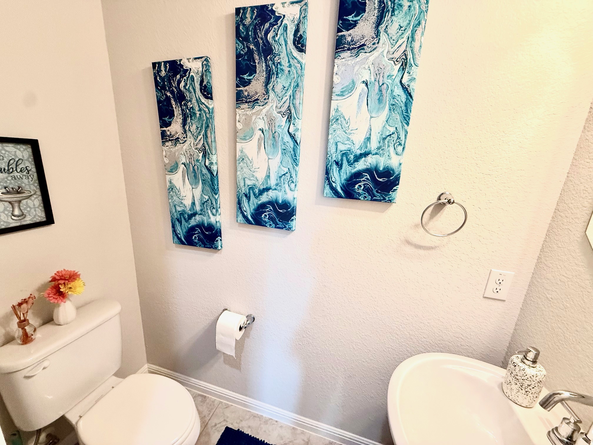3625 Garrano Bend Leander, TX 78641 - Photo 25 of 31 a white toilet sitting next to a bathroom sink and a mirror