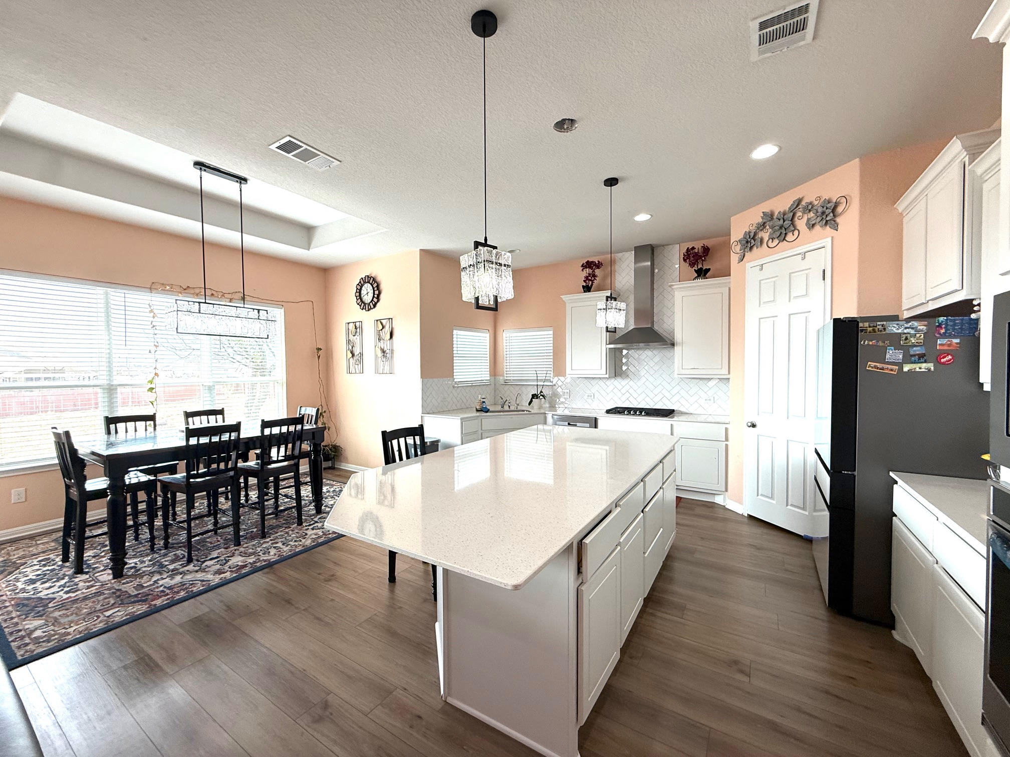 3625 Garrano Bend Leander, TX 78641 - Photo 4 of 31 a large kitchen with kitchen island a wooden floor