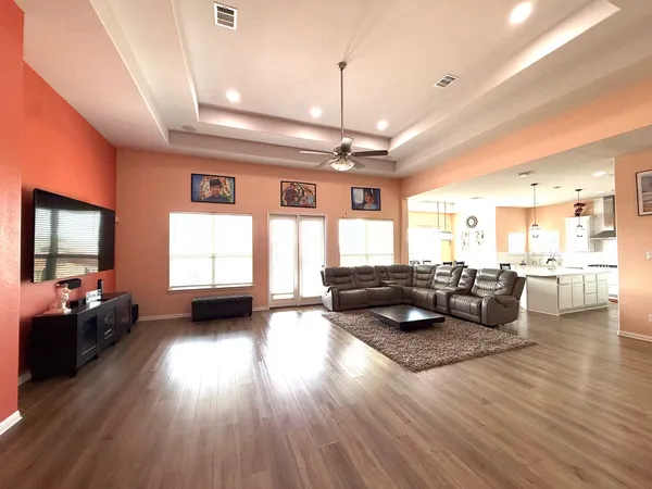 a living room with furniture and wooden floor