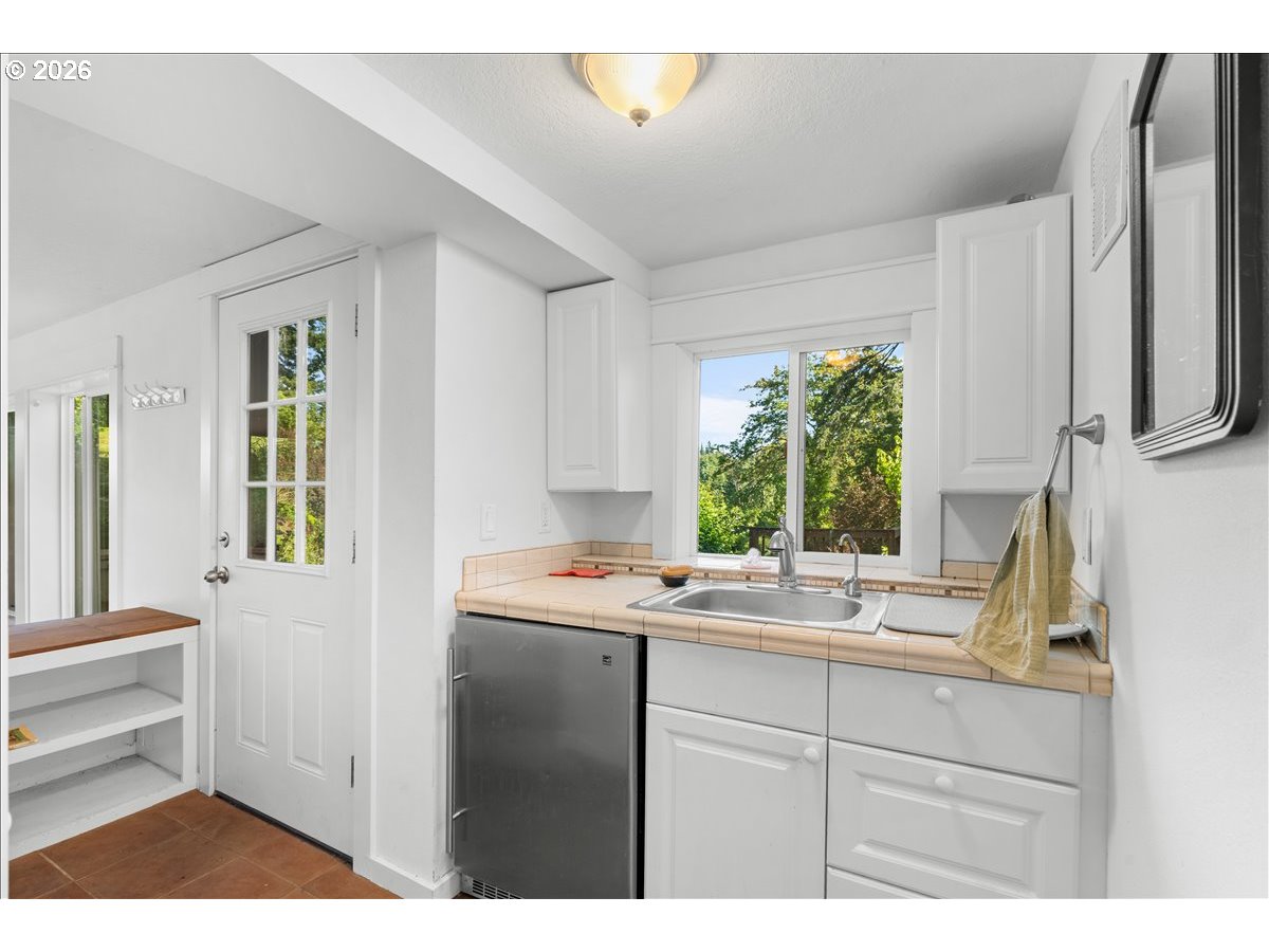 772 Division Street Oregon City, OR 97045 - Photo 26 of 47 a kitchen with a window sink and cabinets