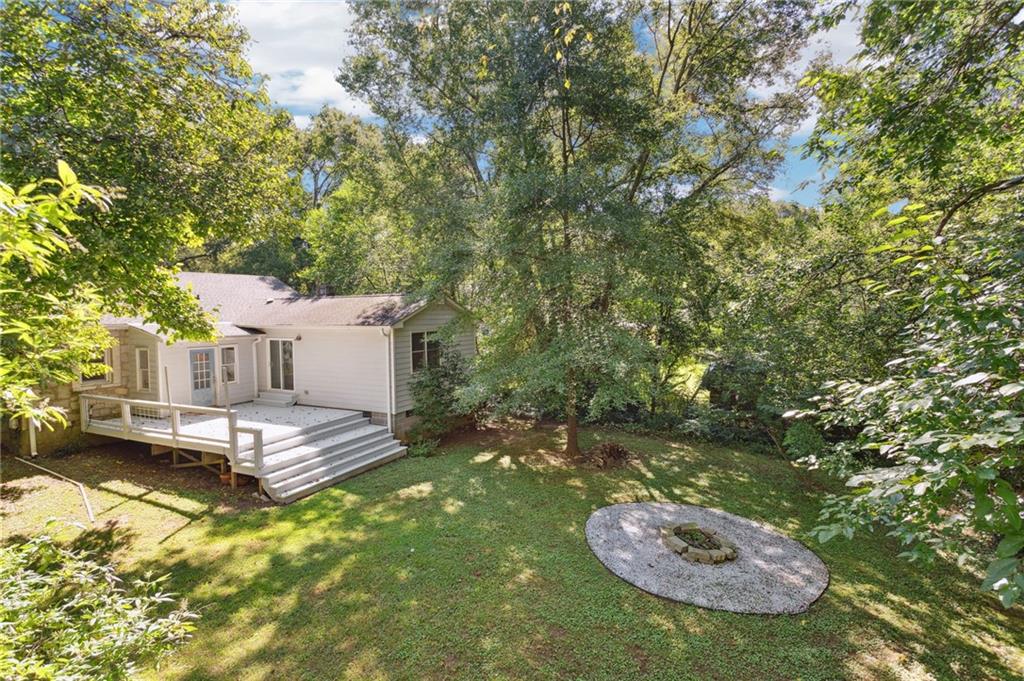 385 Sunset Drive Athens, GA 30606 - Photo 7 of 48 a backyard of a house with table and chairs