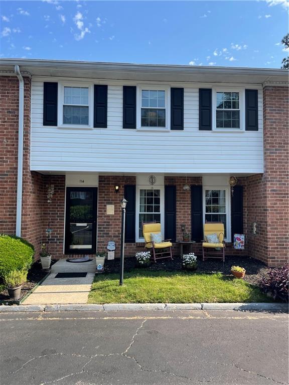 6520 Roswell Road, Unit 114 Atlanta, GA 30328 - Photo 1 of 1 a front view of a house with a garden and plants