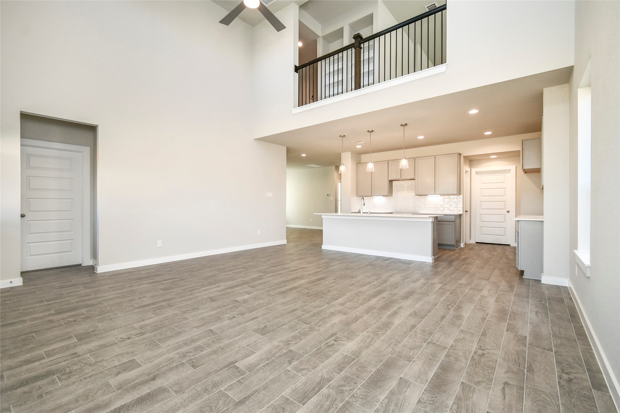 11114 Crocus Drive Houston, TX 77044 - Photo 16 of 28 a view of a hallway with wooden floor and kitchen view