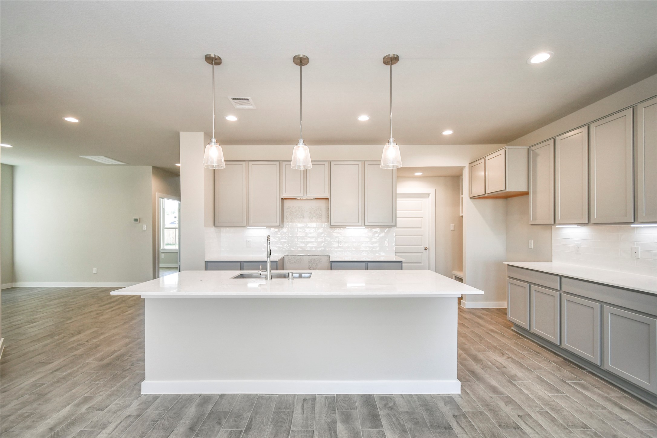 11114 Crocus Drive Houston, TX 77044 - Photo 15 of 28 a large kitchen with kitchen island a sink a center island a stove and a cabinets