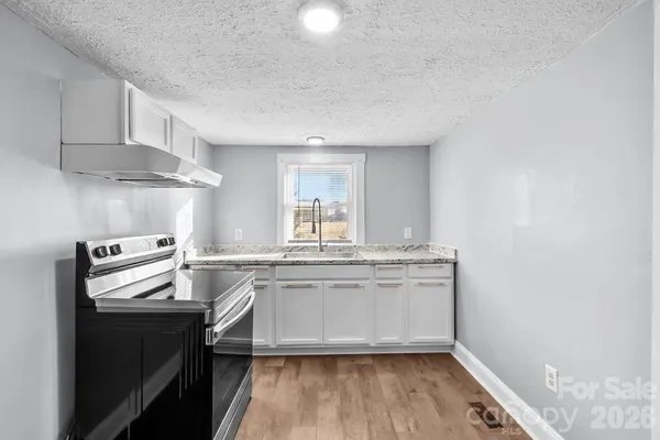 a kitchen with stainless steel appliances granite countertop a stove and a sink