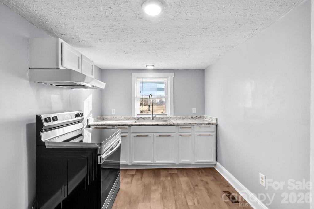 4582 Burkemont Road Morganton, NC 28655 - Photo 3 of 11 a kitchen with stainless steel appliances granite countertop a stove and a sink