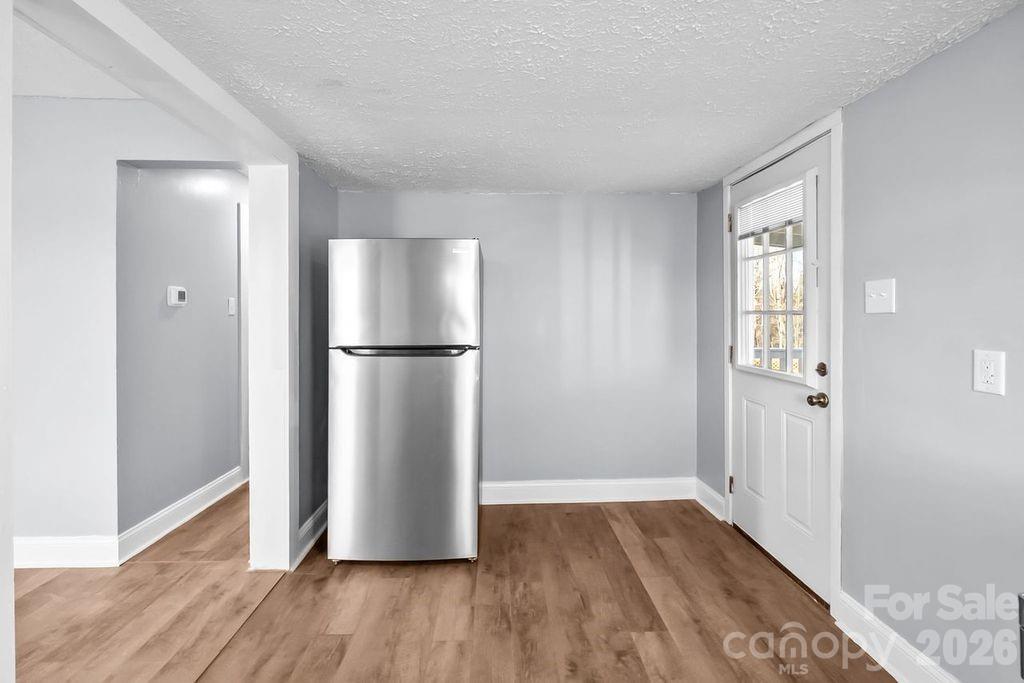 4582 Burkemont Road Morganton, NC 28655 - Photo 4 of 11 a view of a refrigerator in kitchen and wooden floor