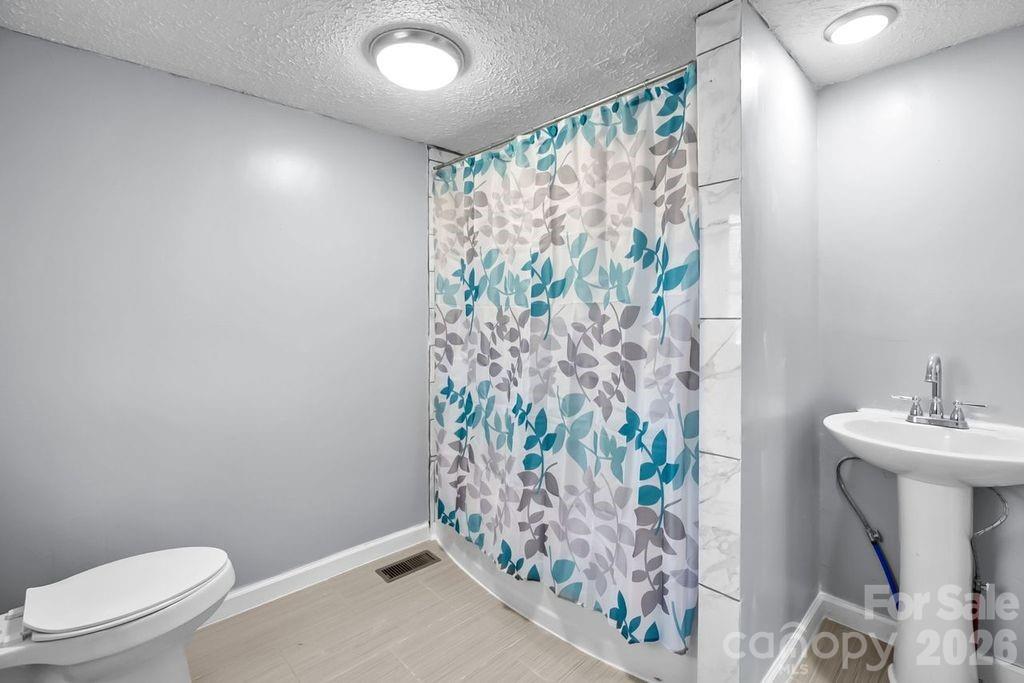 4582 Burkemont Road Morganton, NC 28655 - Photo 9 of 11 a bathroom with a sink toilet and shower