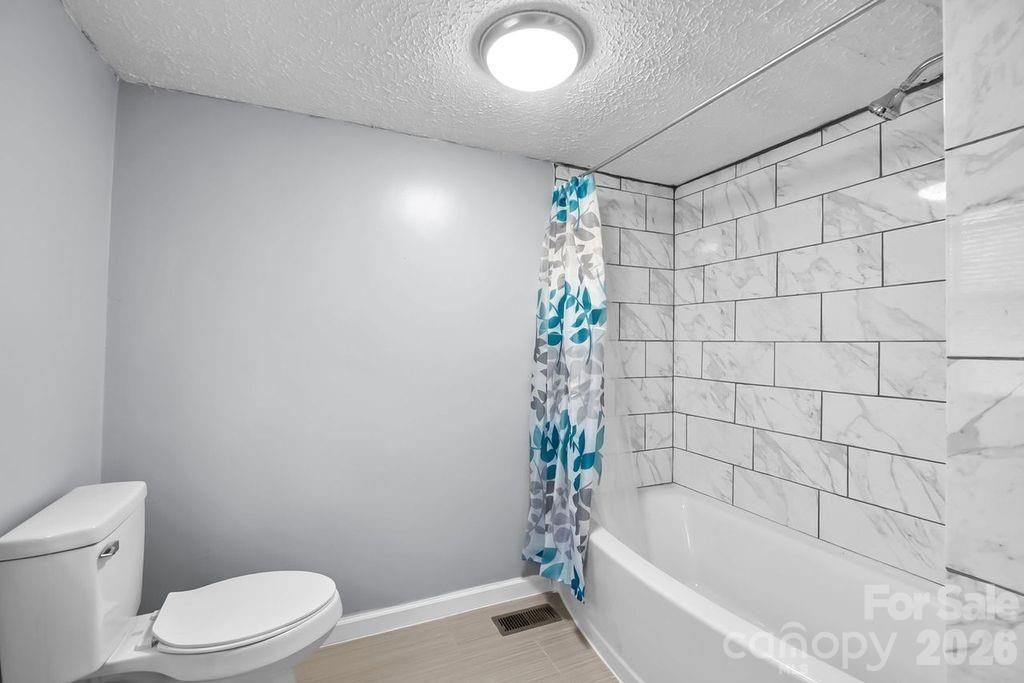 4582 Burkemont Road Morganton, NC 28655 - Photo 10 of 11 a bathroom with a toilet and shower
