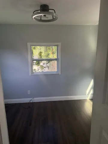 a view of a room with wooden floor and windows