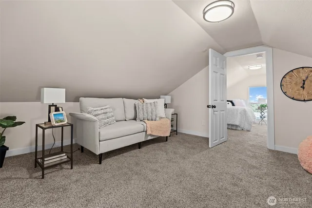 a living room with furniture and a clock