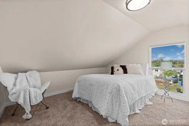 a bedroom with a bed and lamp