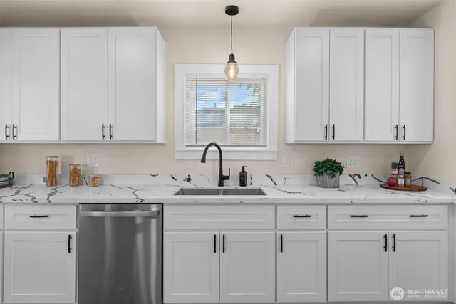 a kitchen with white cabinets and white appliances
