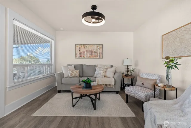 a living room with furniture and wooden floor