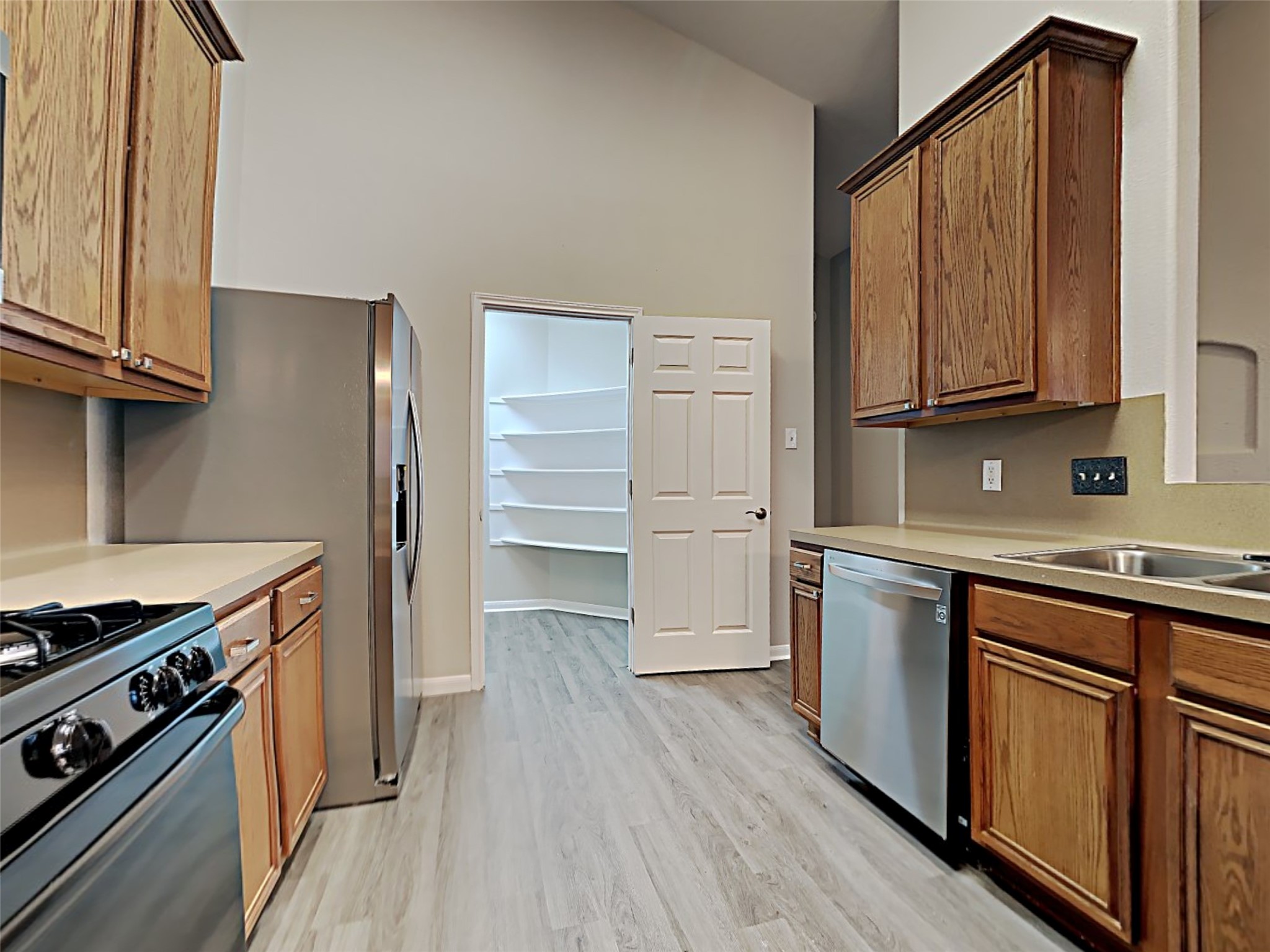 15507 Riford Drive Cypress, TX 77429 - Photo 4 of 15 a kitchen with granite countertop wooden floors and stainless steel appliances