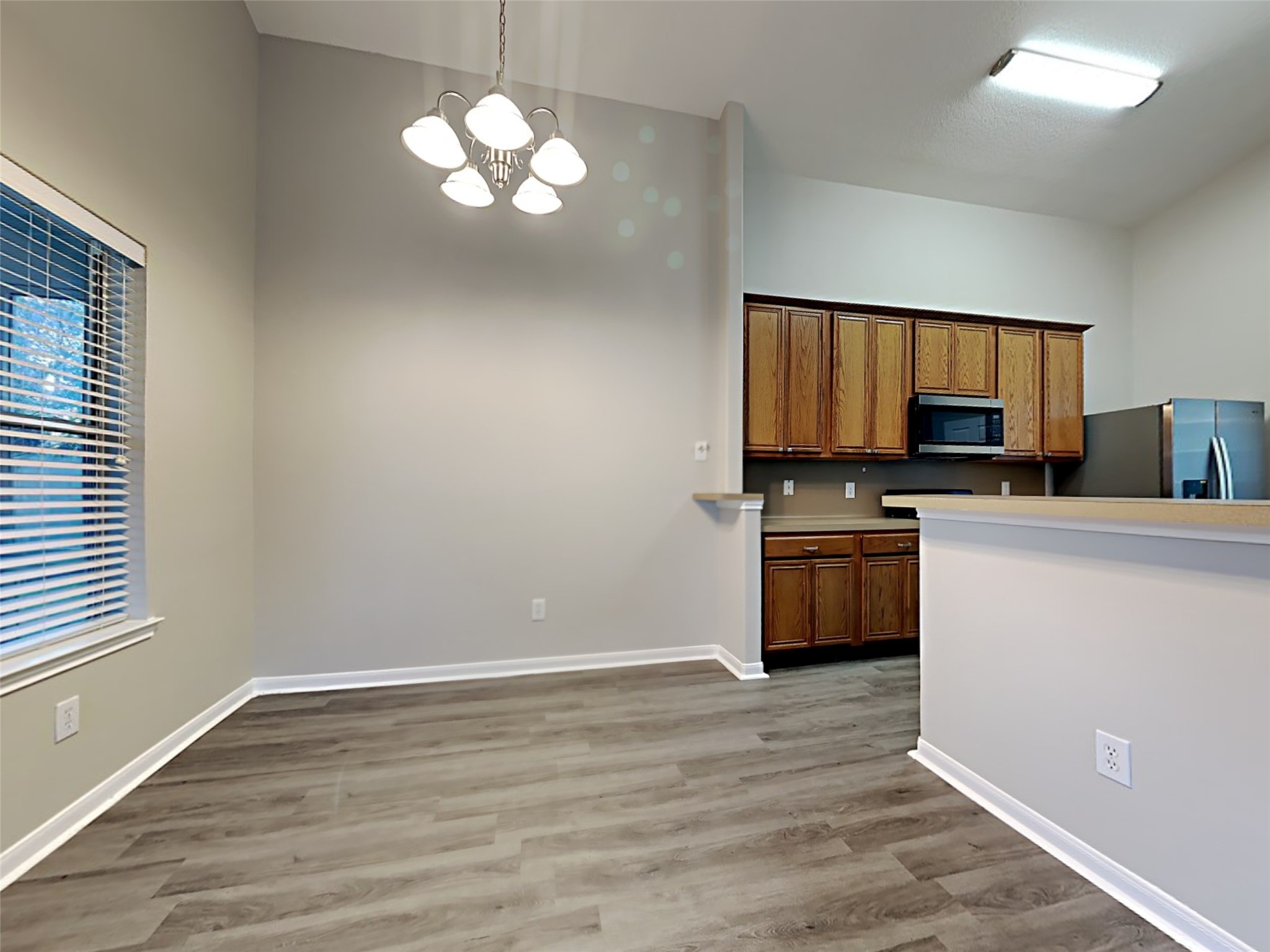 15507 Riford Drive Cypress, TX 77429 - Photo 5 of 15 a kitchen with granite countertop a stove top oven a sink dishwasher and a microwave oven on the wooden floor