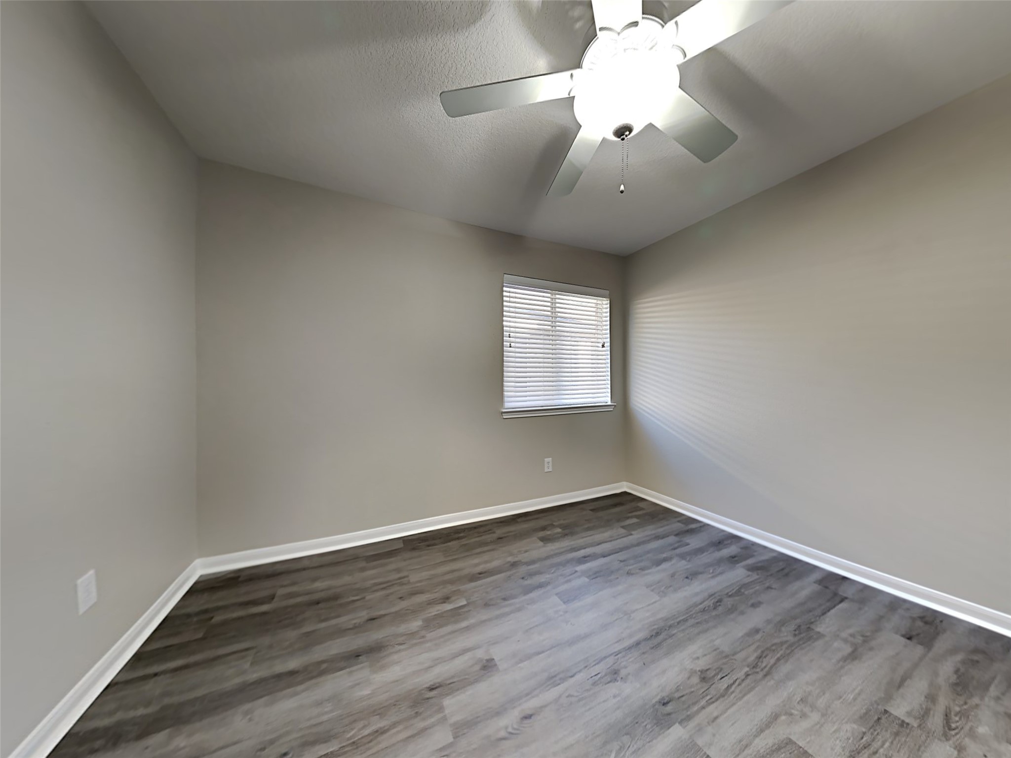 15507 Riford Drive Cypress, TX 77429 - Photo 6 of 15 an empty room with wooden floor and windows