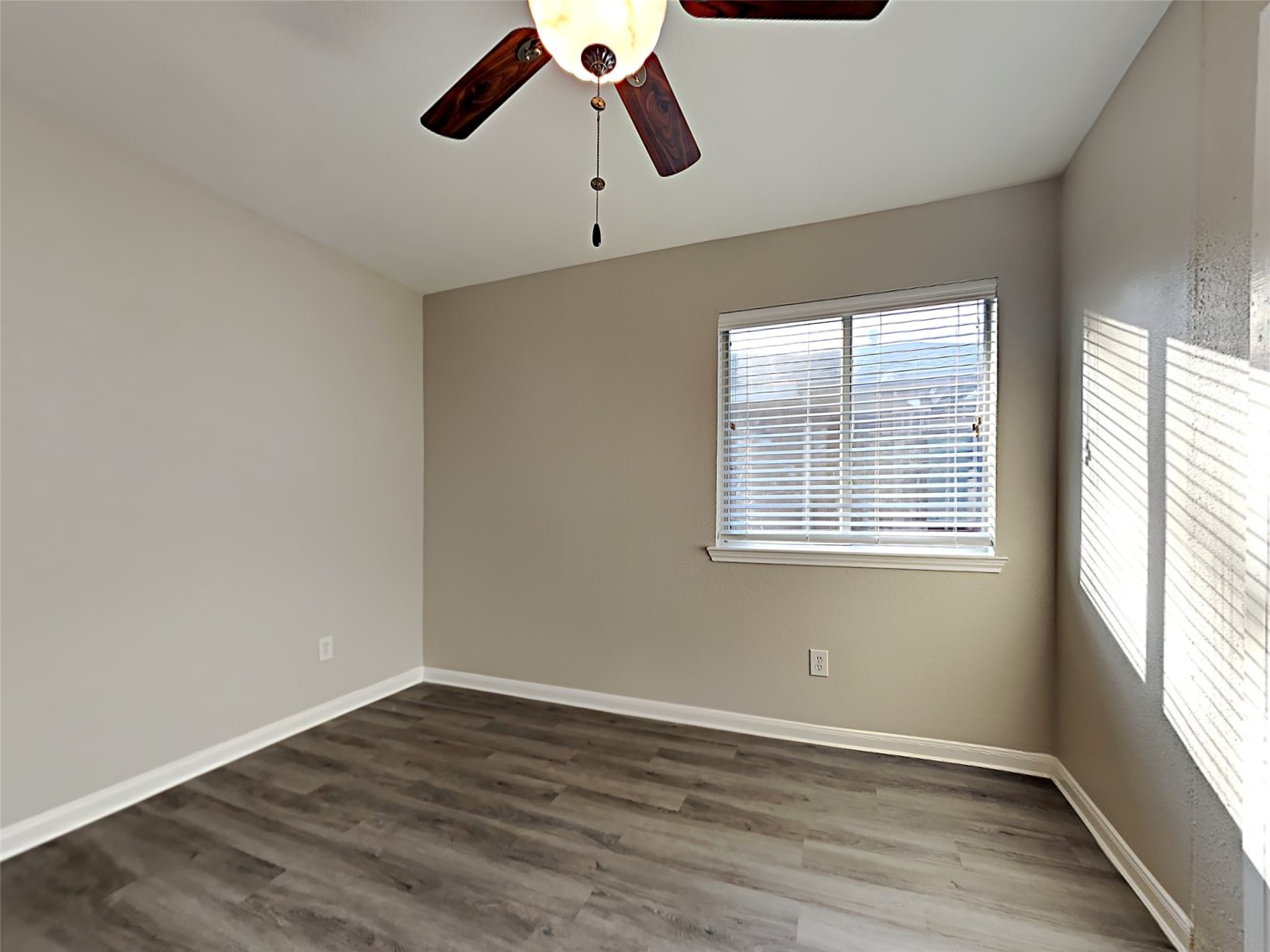 15507 Riford Drive Cypress, TX 77429 - Photo 7 of 15 an empty room with wooden floor fan and windows