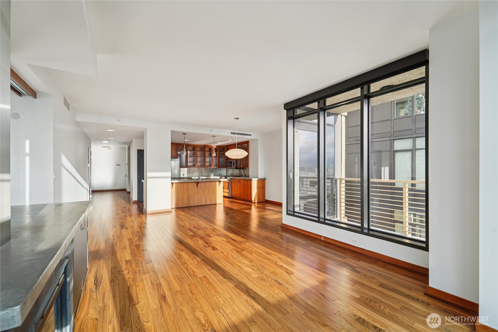 2716 Elliott Avenue, Unit 802 Seattle, WA 98121 - Photo 11 of 34 a view of a living room with wooden floor and a large window