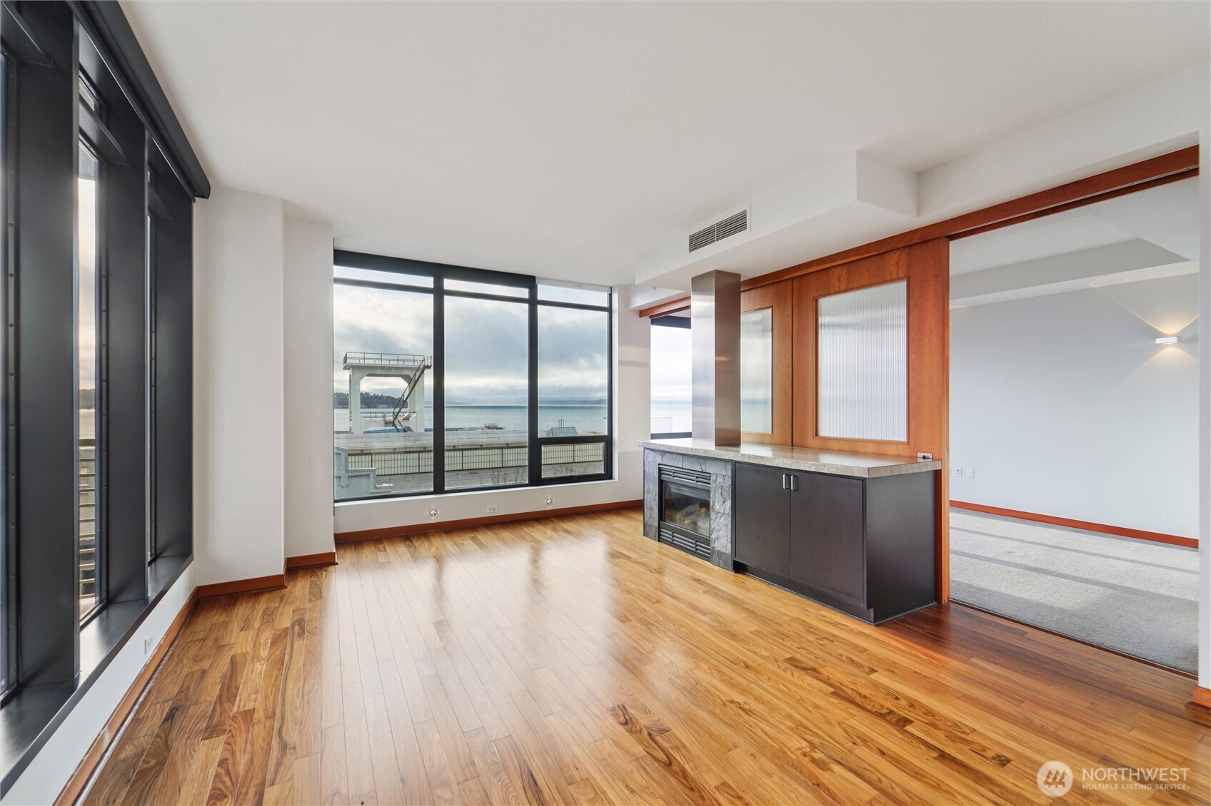 2716 Elliott Avenue, Unit 802 Seattle, WA 98121 - Photo 13 of 34 wooden floor in an empty room with a window
