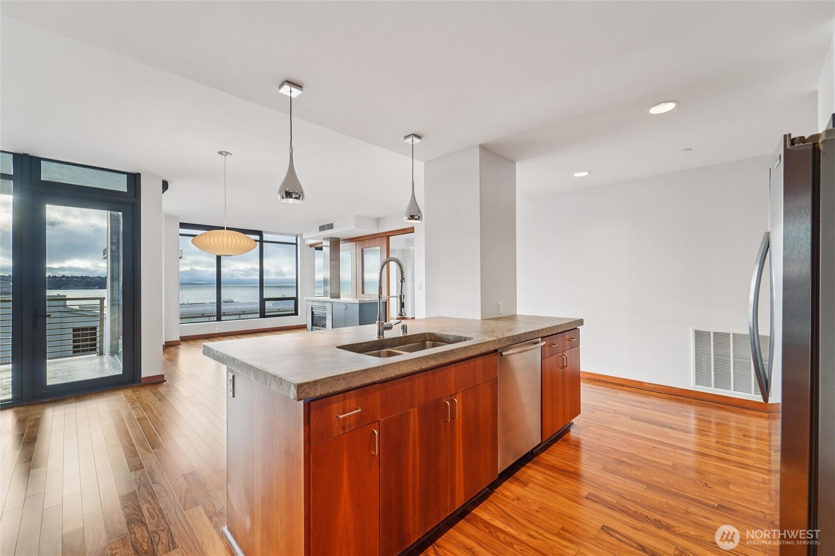 2716 Elliott Avenue, Unit 802 Seattle, WA 98121 - Photo 19 of 34 a kitchen with stainless steel appliances granite countertop wooden floors and sink