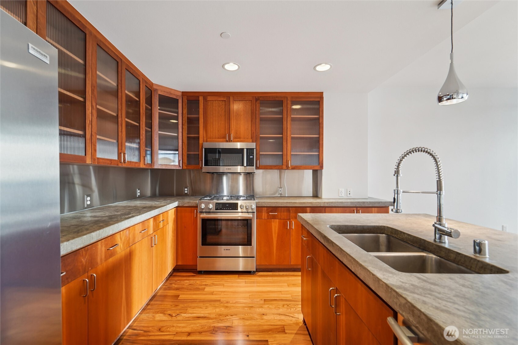 2716 Elliott Avenue, Unit 802 Seattle, WA 98121 - Photo 20 of 34 a kitchen with stainless steel appliances granite countertop a sink and a stove