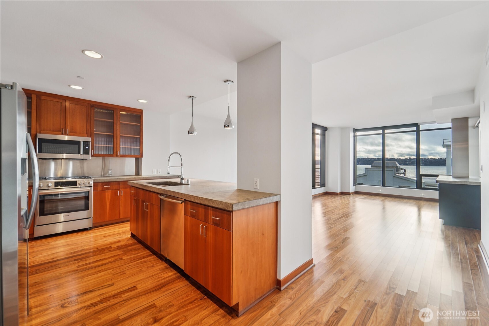 2716 Elliott Avenue, Unit 802 Seattle, WA 98121 - Photo 23 of 34 a kitchen with stainless steel appliances granite countertop a stove and a wooden floors