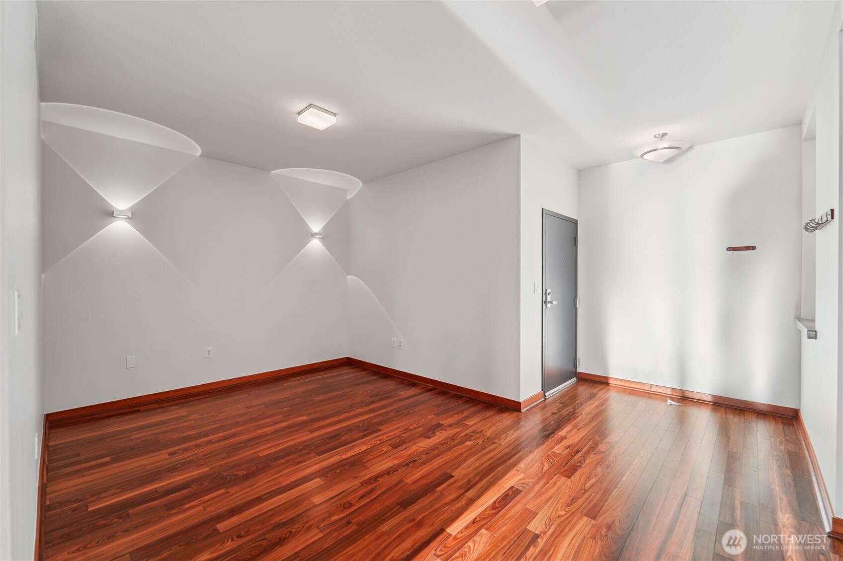 2716 Elliott Avenue, Unit 802 Seattle, WA 98121 - Photo 32 of 34 a view of a room with wooden floor and white walls