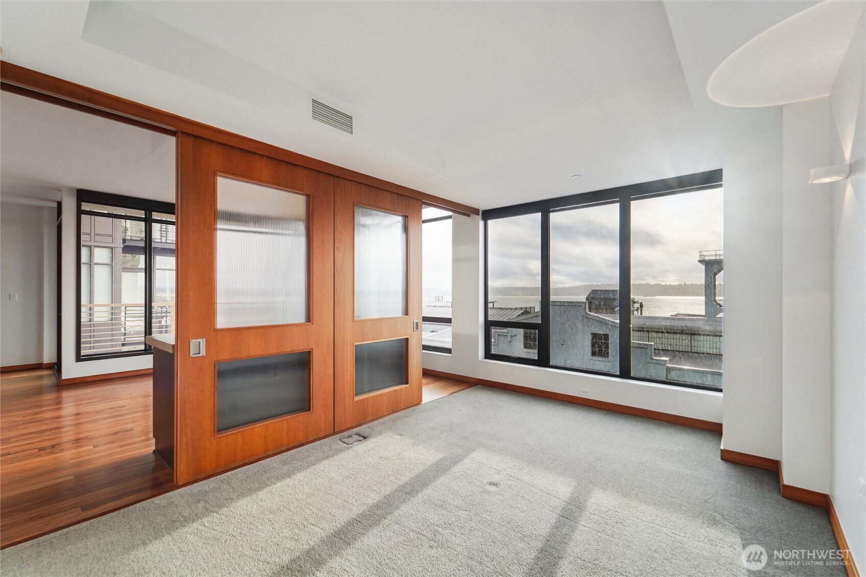 2716 Elliott Avenue, Unit 802 Seattle, WA 98121 - Photo 4 of 34 an empty room with sliding glass door and mountain view