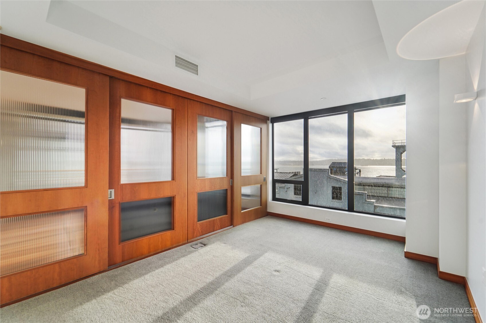 2716 Elliott Avenue, Unit 802 Seattle, WA 98121 - Photo 5 of 34 an empty room with sliding glass door and outer view