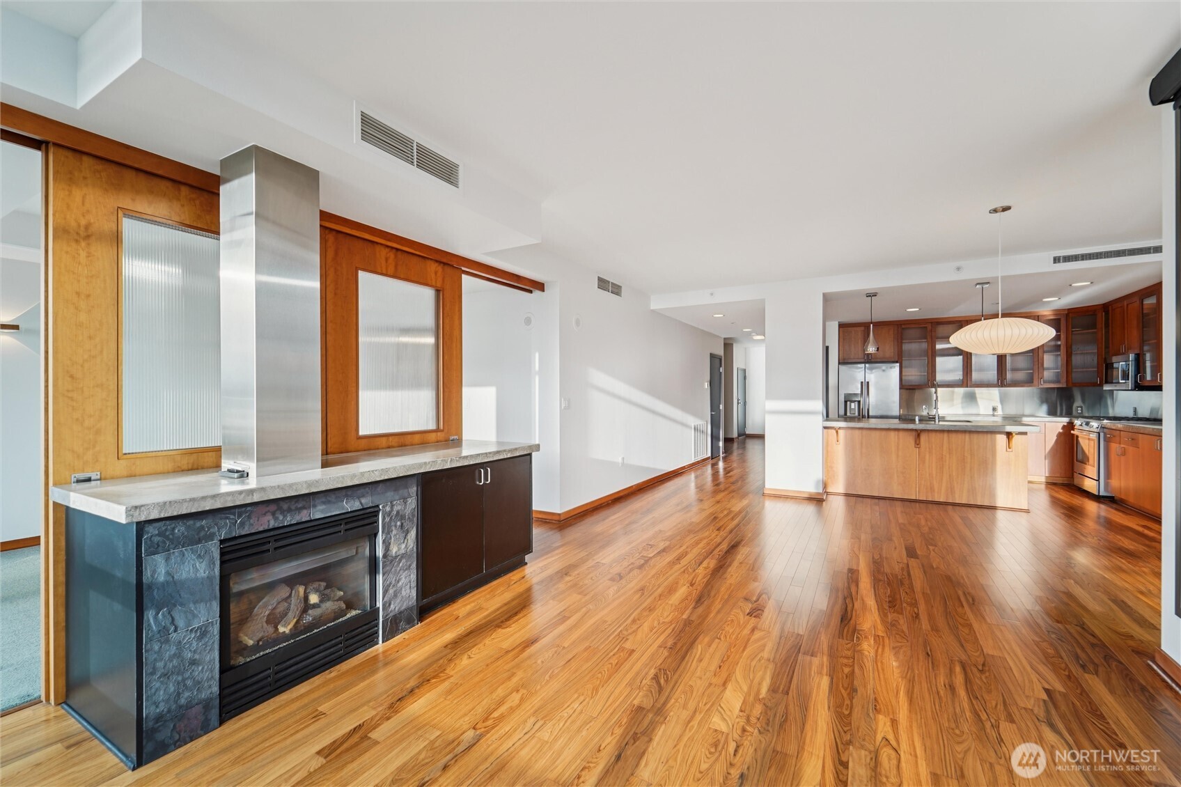 2716 Elliott Avenue, Unit 802 Seattle, WA 98121 - Photo 10 of 34 a open kitchen with a sink and wooden floor