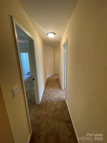 a view of a hallway to rooms