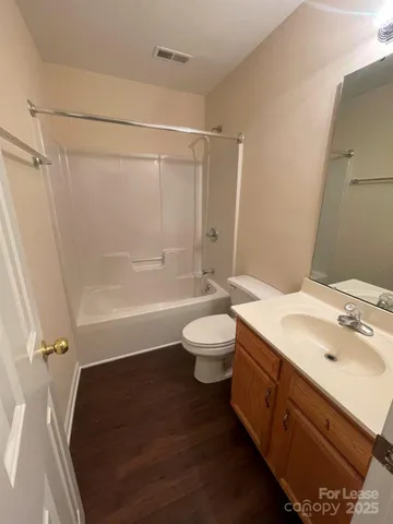 a bathroom with a double vanity sink toilet mirror and shower