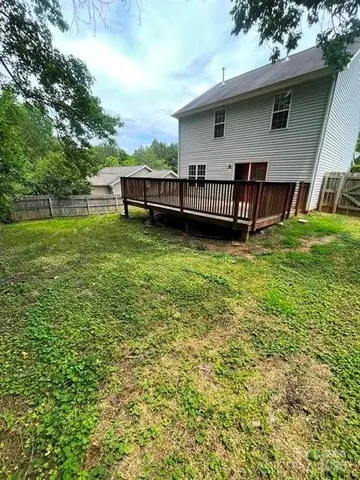 a view of a house with a backyard