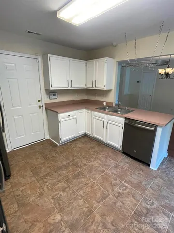 a kitchen with stainless steel appliances granite countertop a sink and cabinets