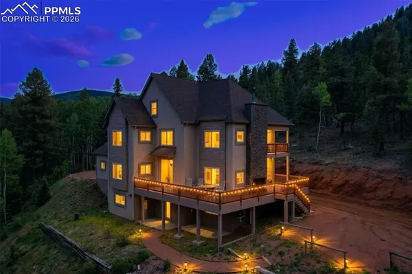 a view of a house with brick walls and flower plants