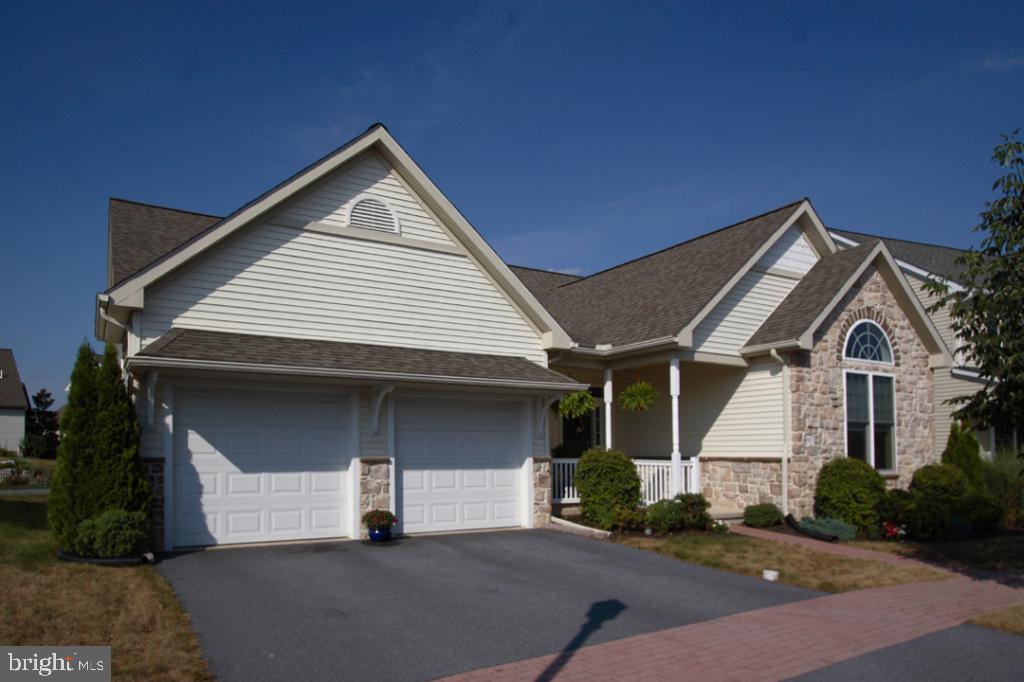a front view of a house with garage