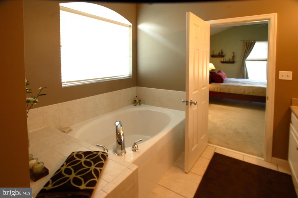 1013 Sloan Street Lititz, PA 17543 - Photo 14 of 22 a bathroom with a bathtub and a shower