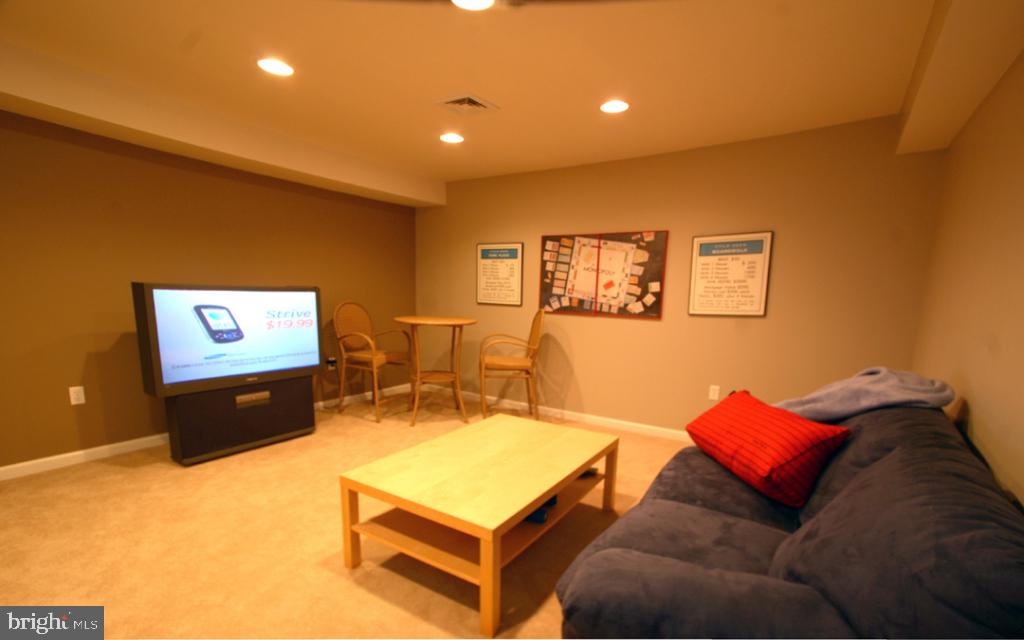 1013 Sloan Street Lititz, PA 17543 - Photo 21 of 22 a living room with furniture a desk and a flat screen tv