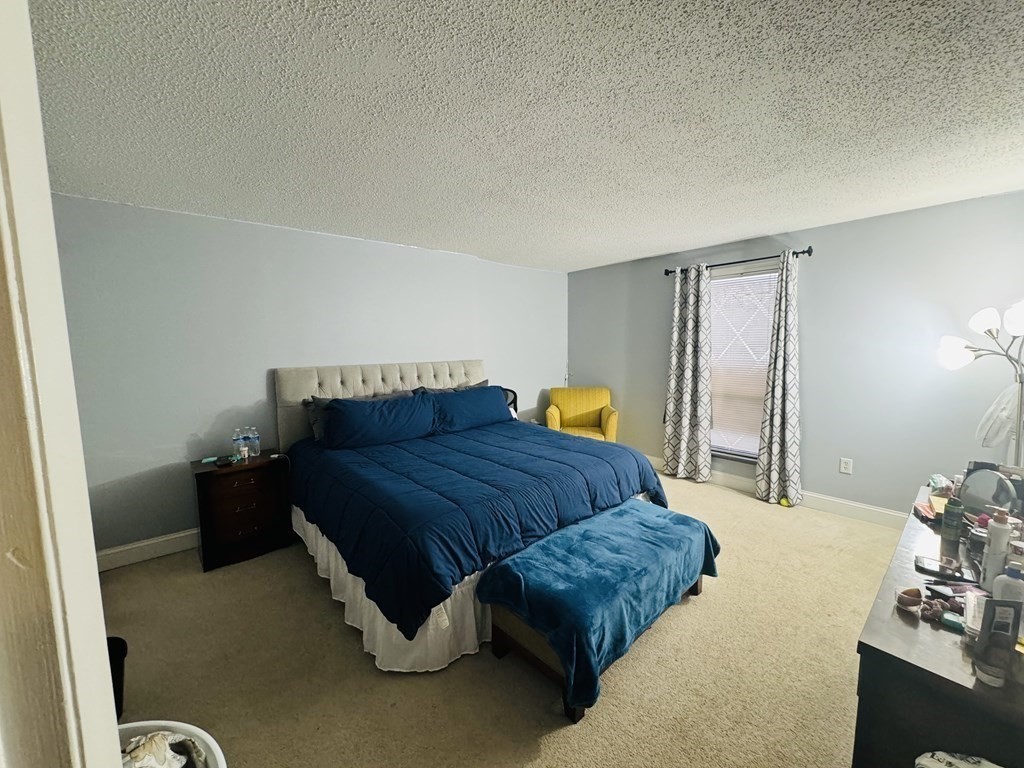6 Shadowbrook Lane, Unit 59 Milford, MA 01757 - Photo 11 of 25 a bedroom with a bed and a dresser