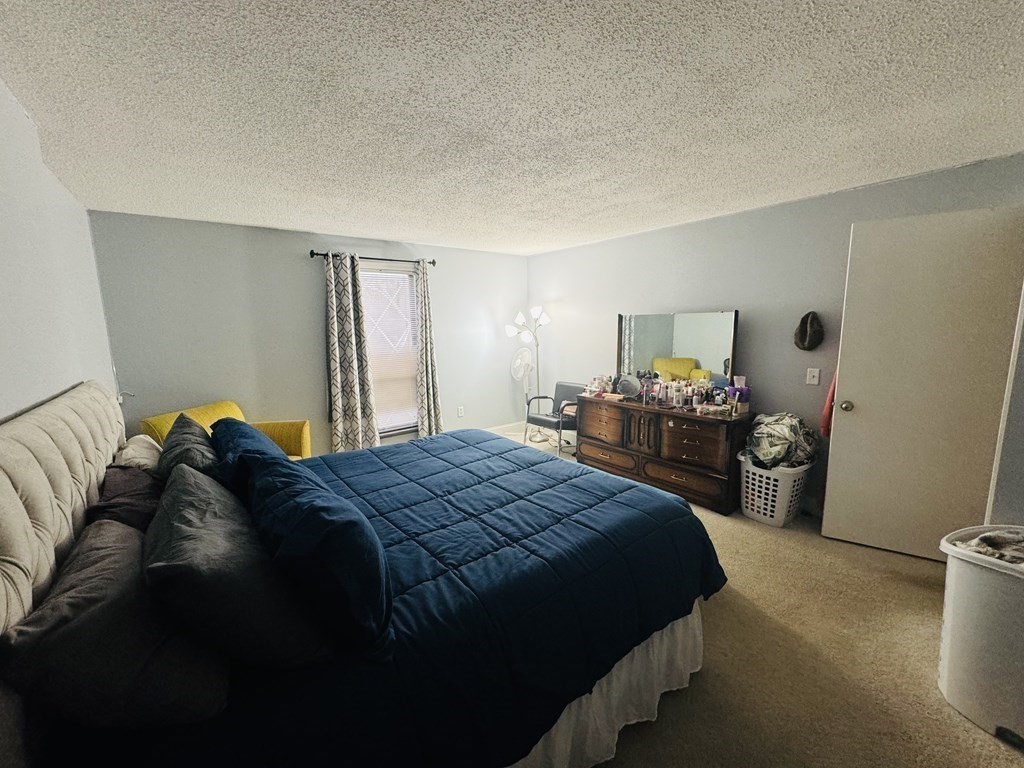 6 Shadowbrook Lane, Unit 59 Milford, MA 01757 - Photo 12 of 25 a bedroom with a bed and a closet