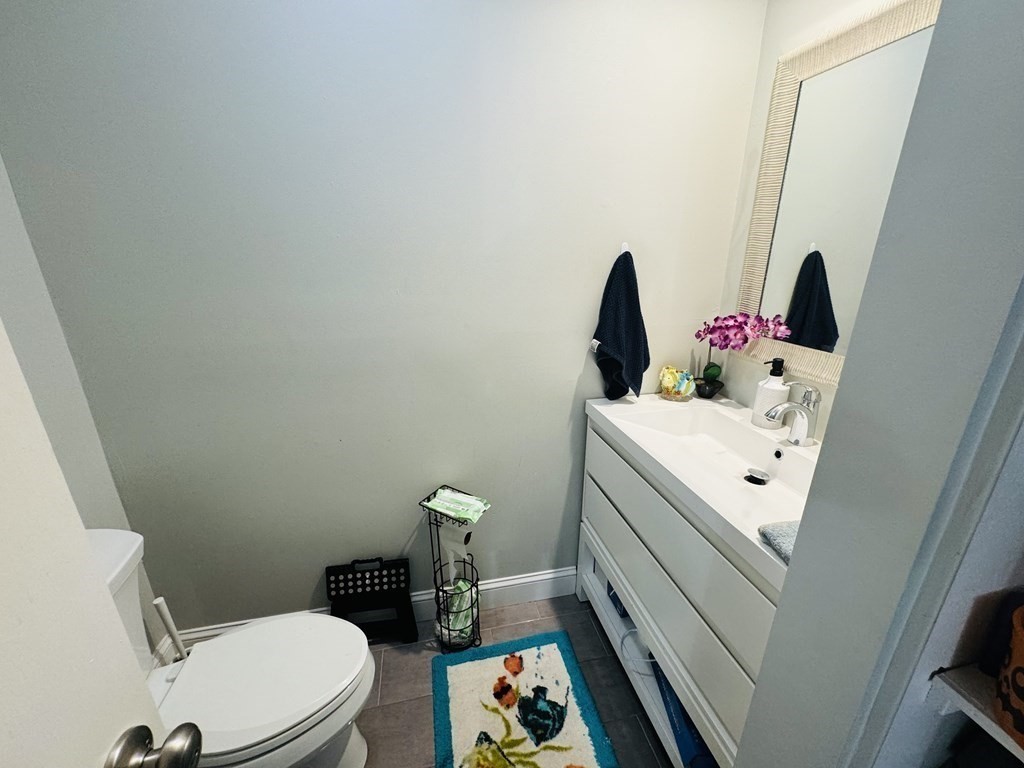6 Shadowbrook Lane, Unit 59 Milford, MA 01757 - Photo 13 of 25 a bathroom with a sink vanity and toilet