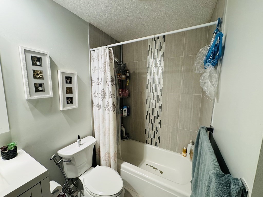 6 Shadowbrook Lane, Unit 59 Milford, MA 01757 - Photo 16 of 25 a bathroom with a toilet and a bathtub